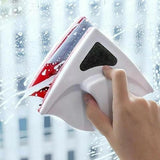 Hand using a window cleaning tool on a snowy window